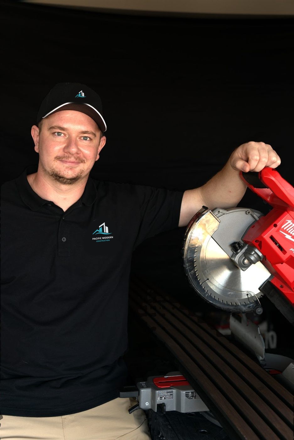 Ruslan, owner of Pacific Modern Construction, with a miter saw