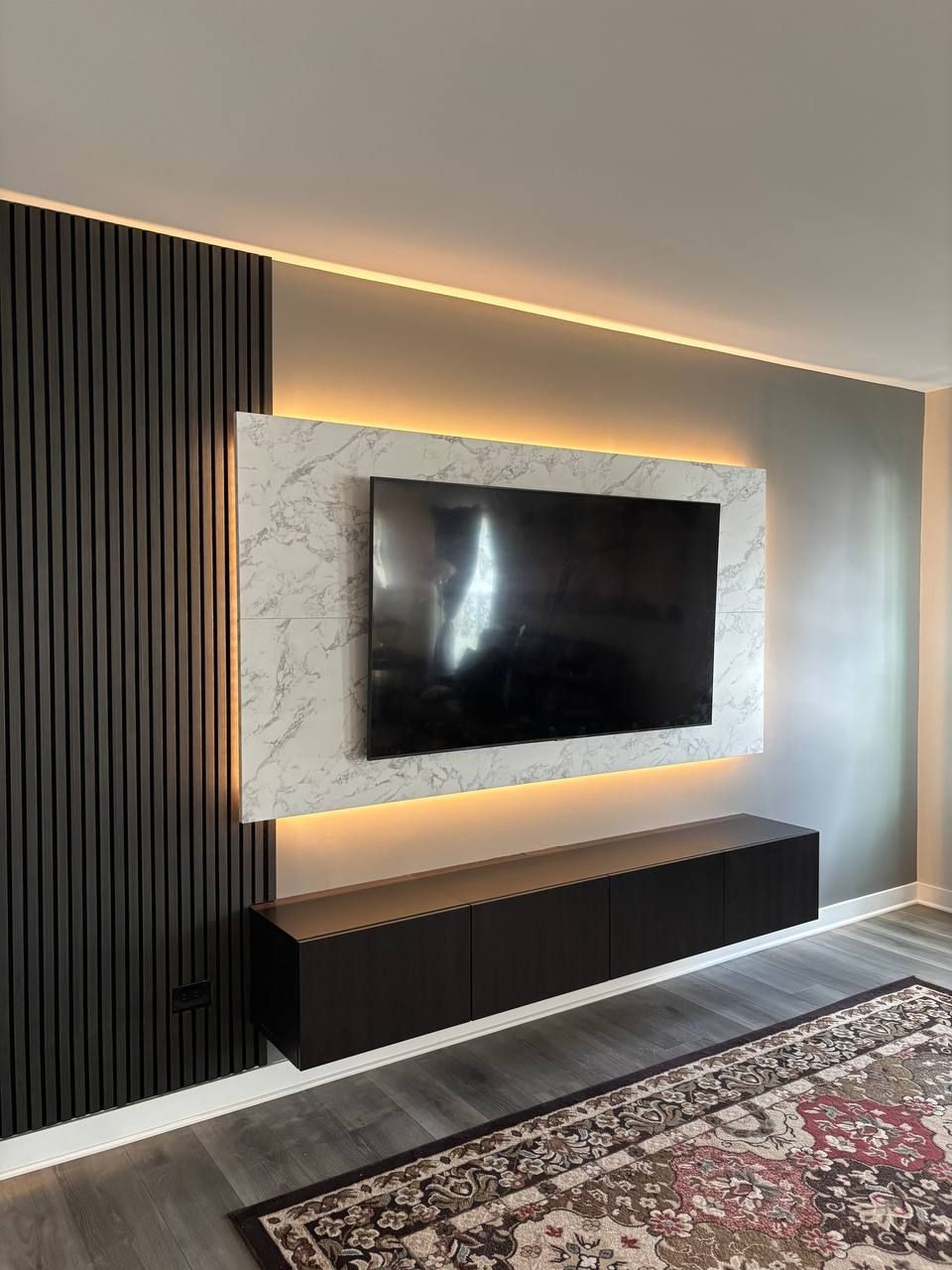 Black slat and marble-look TV wall